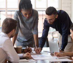 Group of people working around a table.