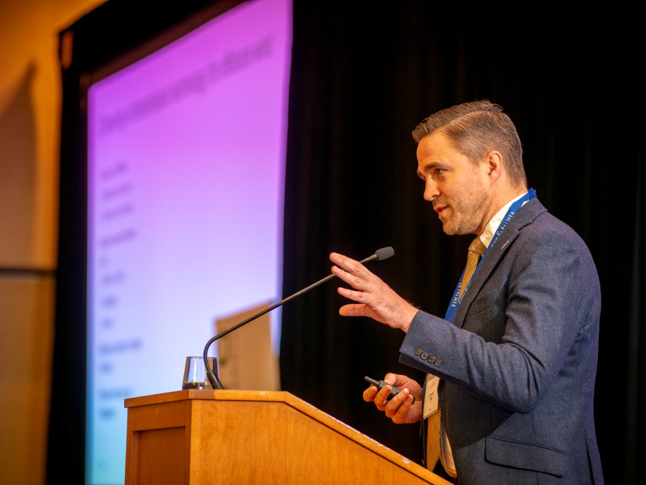 Expressive conference speaker at podium